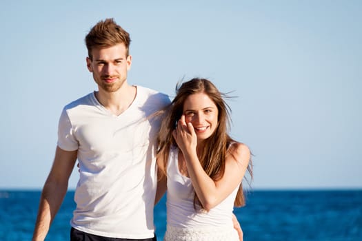 happy young couple on the beach carefree summertime holiday