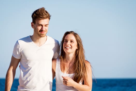 happy young couple on the beach carefree summertime holiday