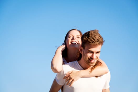 happy young couple on the beach carefree summertime holiday