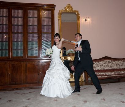 The bride pulls groom for a tie