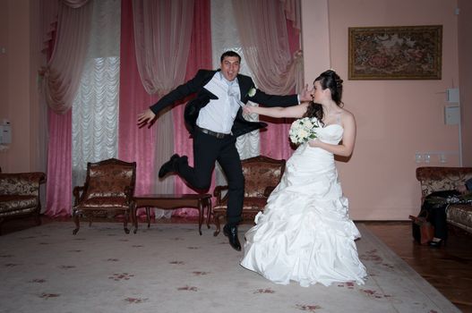 The bride pulls groom for a tie