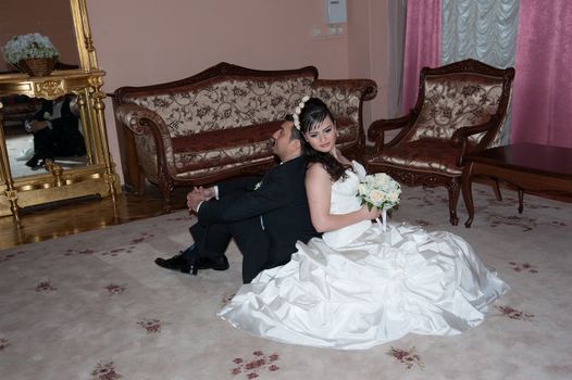 bride and groom in the living room sitting on the floor