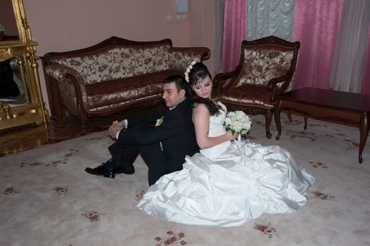 bride and groom in the living room sitting on the floor