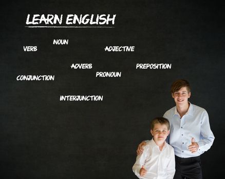 Thumbs up boy dressed up as business man with teacher man and learn English on blackboard background
