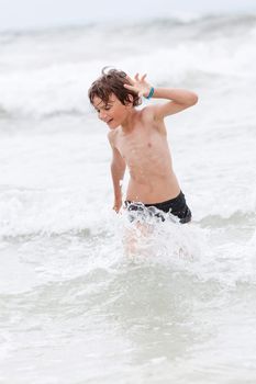 young little boy in water summer holiday having fun sea ocean 