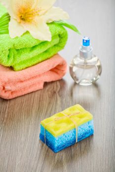 bath sponge soap flower bottle and towels