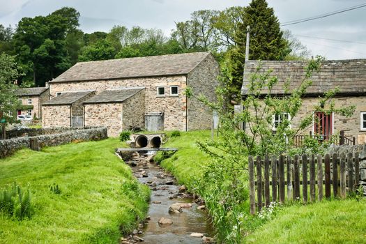 A stream running through a picturesque village in England