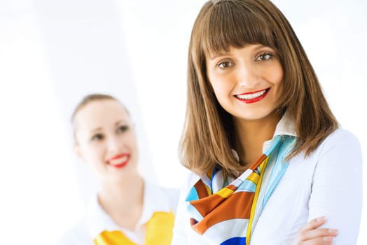 Portrait of a young successful business woman standing against colleagues