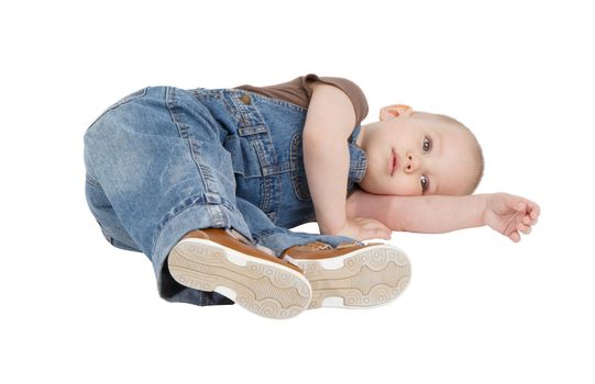 child is lying on the floor on a white background