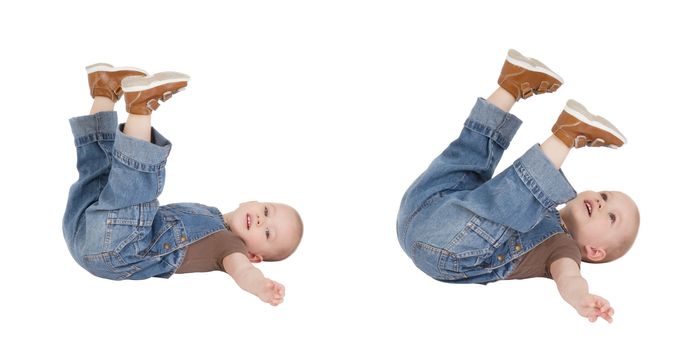 child is lying with lifted legs on a white background
