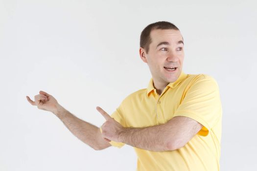 surprised man points out off somewhere on a light background