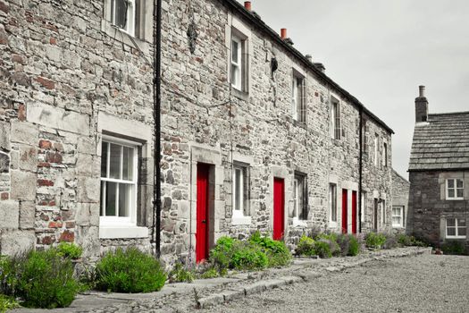 Stone cottages around a courtyard in Blanchland village, Northumberland