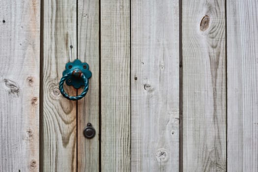 Close up of a ring handle on a wooden gate