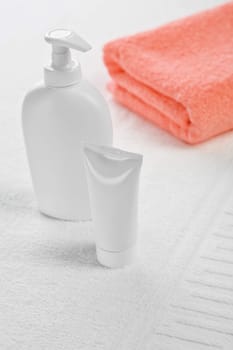 pink towel tube and bottle