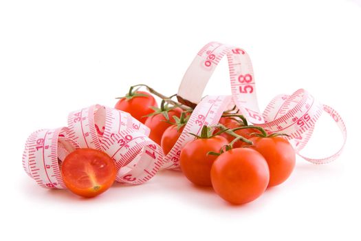 Small bunch of tomatoes with tailor tape on white