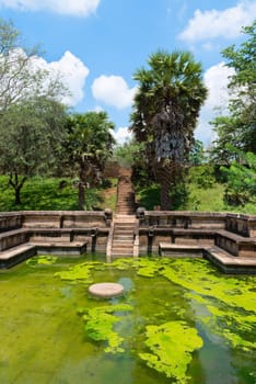 Ruins of  Kumara Pokuna (royal bathing pond) in ancient Sri Lanka capital Polonnaruwa under blue sly