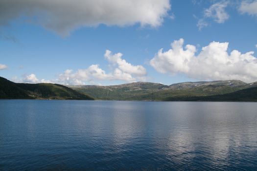 The picture shows somewhere in Norway with mountains and fjords.