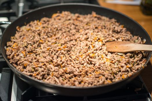 Restaurant : Cooking minced meat in a huge frying pan