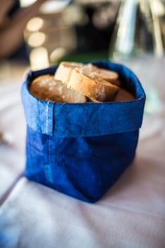 decorative bread basket made of blue fabric on table in great light