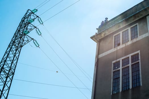 Old derelict electric power substation in Liguria, Italy in bright sunlight