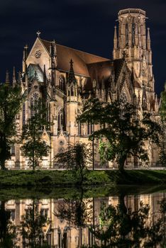 Beautiful Johanneskirche protestant church over Feuersee (Fire lake) in Stuttgart, Germany at night