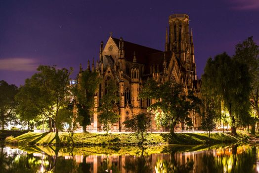 Beautiful Johanneskirche protestant church over Feuersee (Fire lake) in Stuttgart, Germany at night in HDR optic