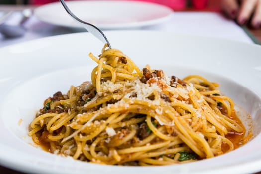 Spaghetti noodles with meat sauce on white plate