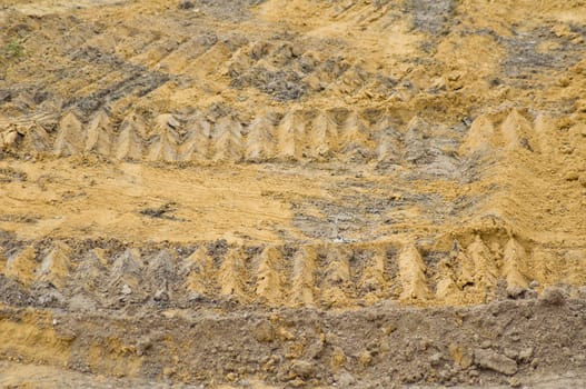 caterpillar wheel on soil background