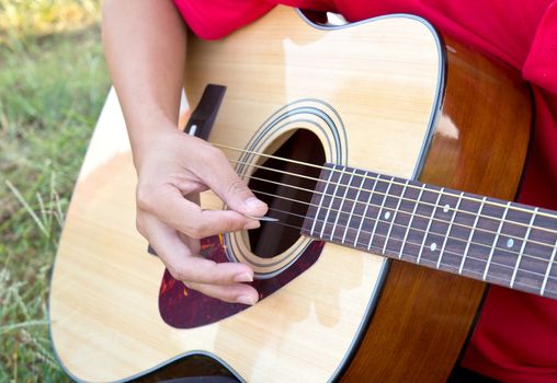 Close up for man playing folk guitar 