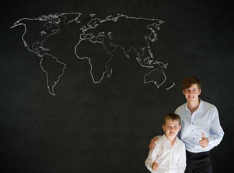 Thumbs up boy dressed up as business man with teacher man and chalk geography world map on blackboard background