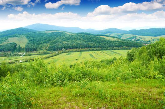 The village is in the distance in the European mountains