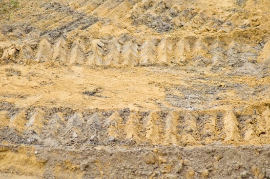 caterpillar wheel on soil background