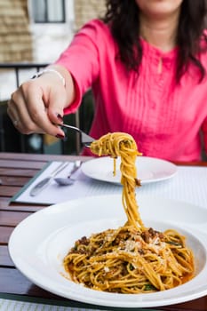 Spaghetti noodles with meat sauce on white plate