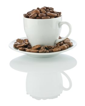 cup on the suaser with coffee beans