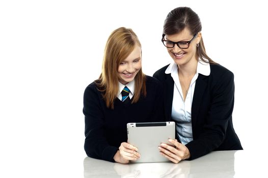 Student with teacher exploring a tablet device