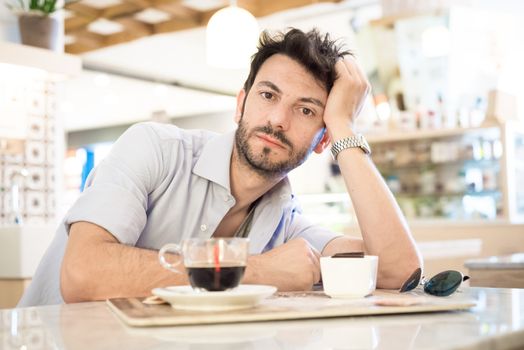 man at the bar drinking coffee in the morning