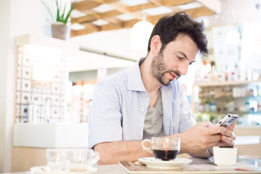 man at the bar on the phone in the morning