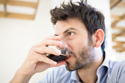 man at the bar drinking coffee in the morning