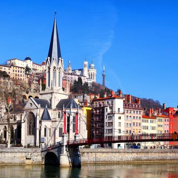 Lyon cityscape from Saone river with colorful houses and footbridge