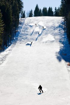 Skiers going down the slope