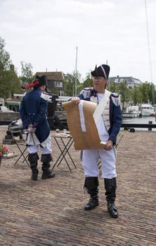 HELLEVOETSLUIS,HOLLAND - JUNE 29:Unidentified man in old france uniform as speaker to the people on the anual arts day,on June 29,2013 in Hellevoetsluis, Holland.This days is once a year to introduce art and culture