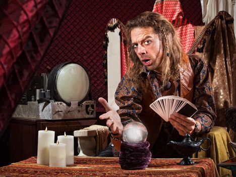 Enticing man with tarot cards and crystal ball
