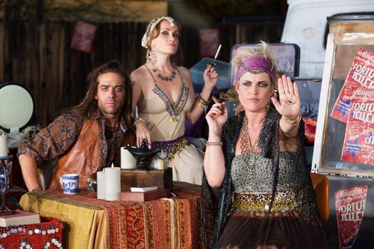 Blond female fortune teller displaying an evil eye in her palm