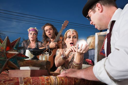 Embarrassed group of people reading a crystal ball