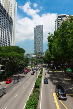 SINGAPORE - JUN 1: Cars drive along famous Orchard road on Jun 1, 2013 in Singapore. This 2.2 kilometer street is the retail hub of the city. It is a major tourist attraction as shopping street.