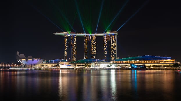 SINGAPORE - JUN 1: Laser show on Marina Bay Sands complex skyline at night on Jun 1, 2013 in Singapore. It is an integrated resort became a  symbol of modern Singapore.