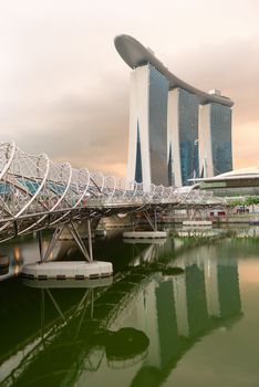 SINGAPORE - JUN 2: The Marina Bay Sands Complex with Helix bridge in front on Jun 02, 2013 in Singapore. Ii is worlds most expensive standalone casino property at SGD8 billion. 