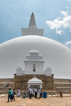 ANURANHAPURA, SRI LANKA - APR 16: Pilgrims pray near white sacred stupa Ruwanmalisaya dagoba on Apr 16, 2013 in Anuradhapura, Sri Lanka