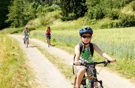 Teenager riding bicycle on trip in sunny day