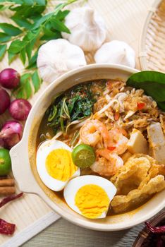 Singaporean prawn noodles or prawn mee. Famous Singapore food spicy fresh cooked har mee in clay pot with hot steam. Asian cuisine.